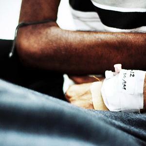 An HIV patients arms in the intensive care unit. At the time this photo was taken, he was given three weeks to live.